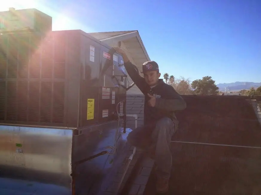 HVAC technician performing Boiler Repair on a rooftop unit in West Windsor
